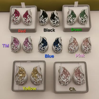 Set of earrings in various colors with color labels on a white surface.