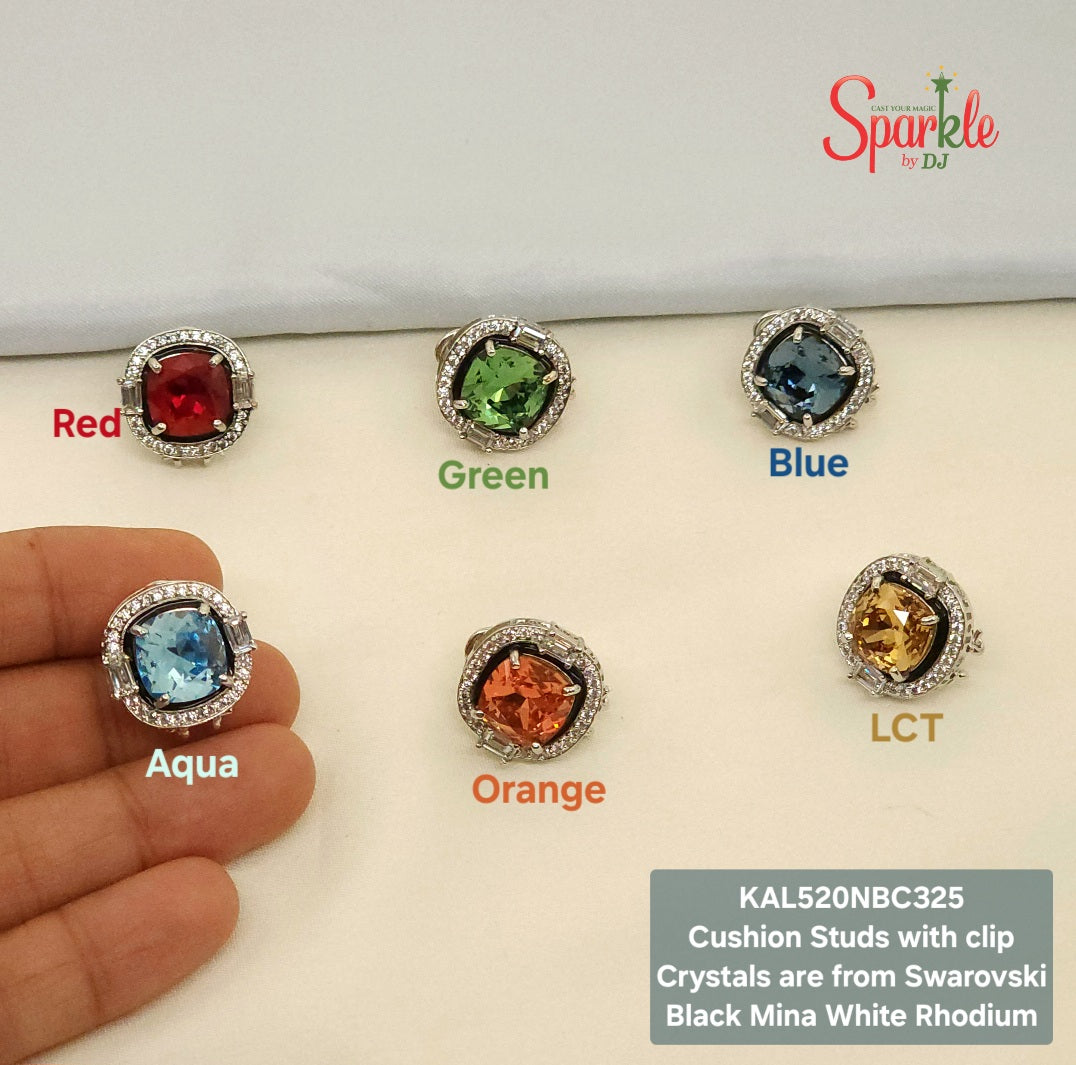 Set of cushion-shaped stud earrings with colored Swarovski Crystals on a white rhodium casing with black mina border. Featuring the brand 'SparklebyDJ'.