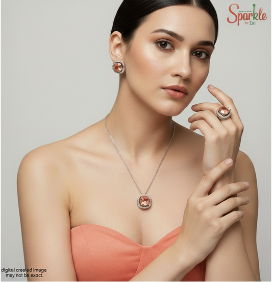 Jewelry set with orange SWAROVSKI crystals and white rhodium plating on a beige background