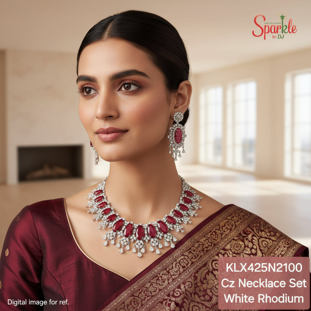 Jewelry set with red stones and white rhodium plating on a beige background, featuring the brand 'Sparkle by DJ'.