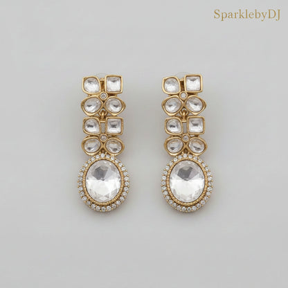 Gold and crystal earrings on a beige background with 'SparklebyDJ' branding.