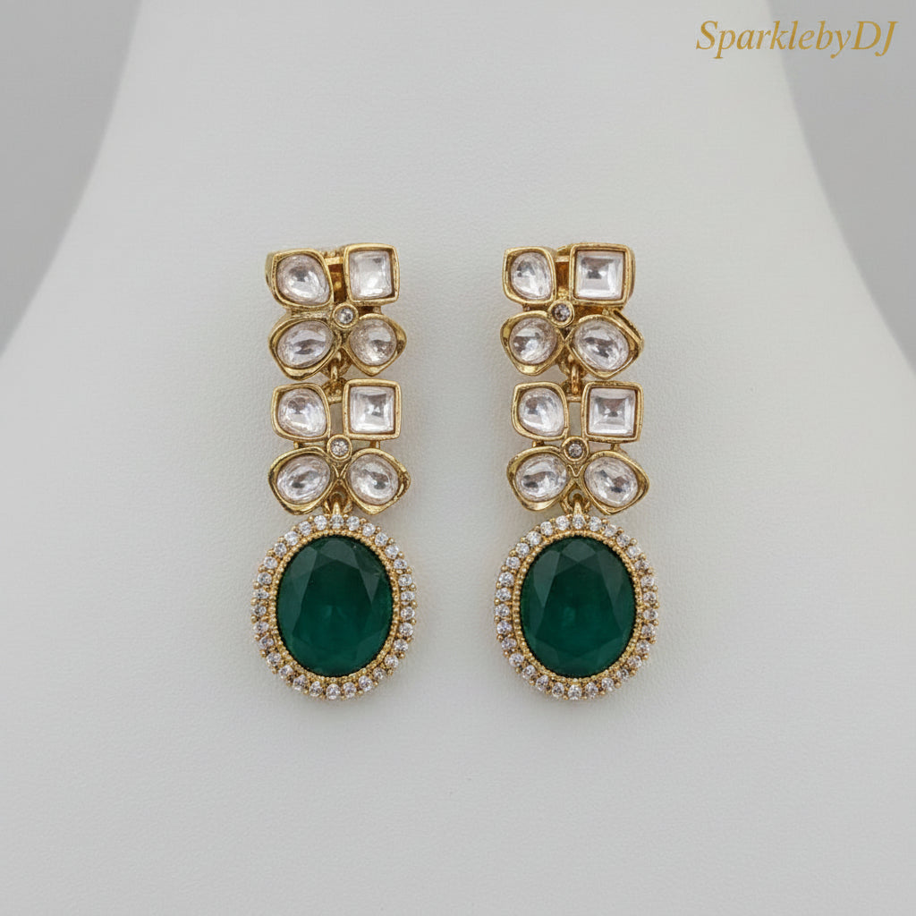 Gold and green earrings with 'Sparkle' branding on a beige background