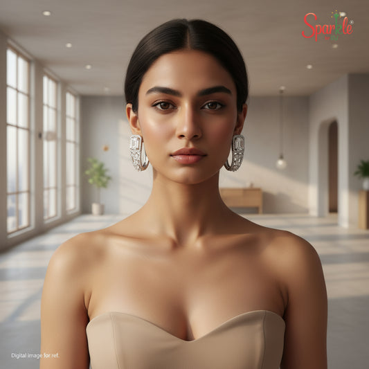 Pair of diamond earrings on a model wearing beige dress featuring the brand 'SparklebyDJ'.