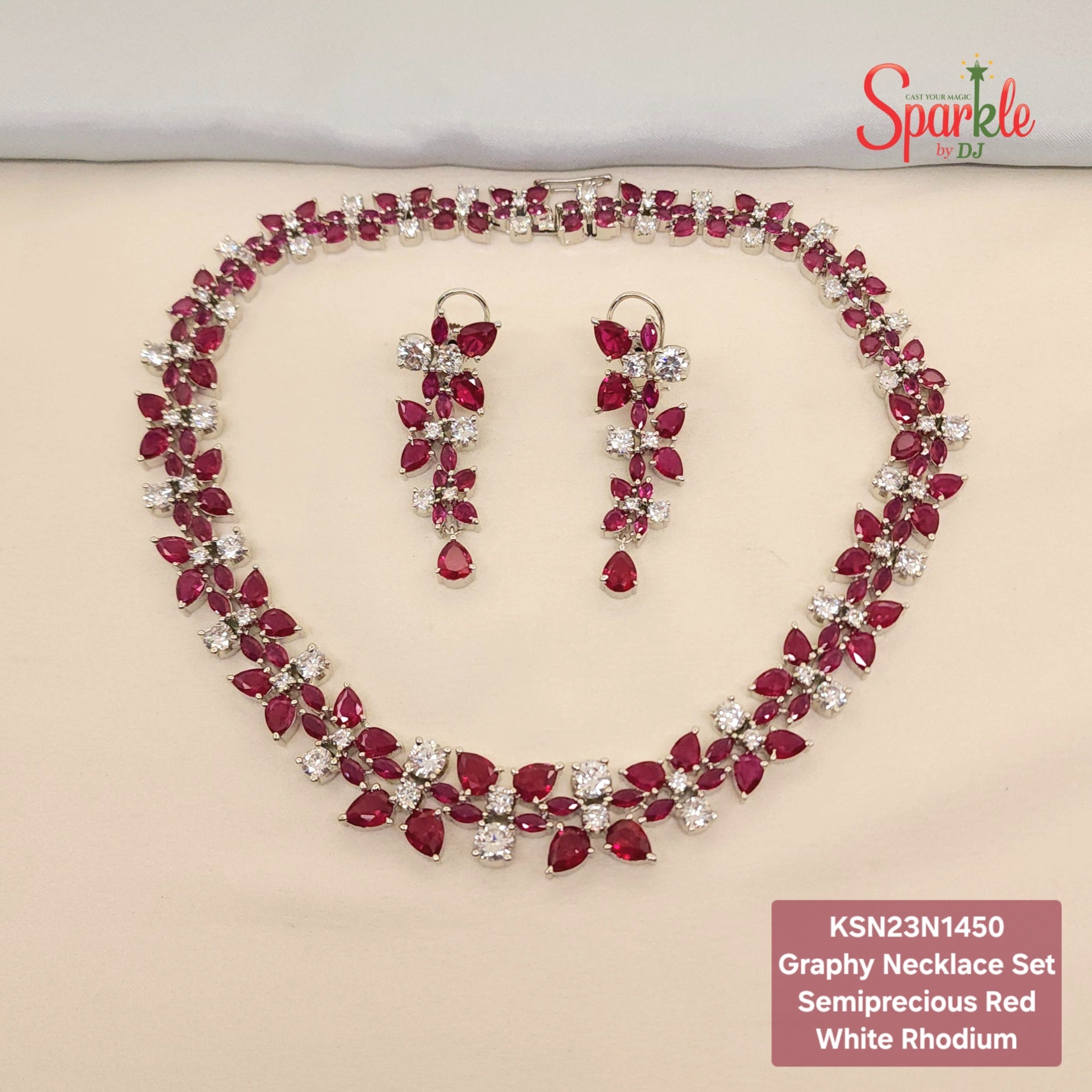 Graphy necklace set with semiprecious red and white stones on a beige surface, branded 'SparklebyDJ'.