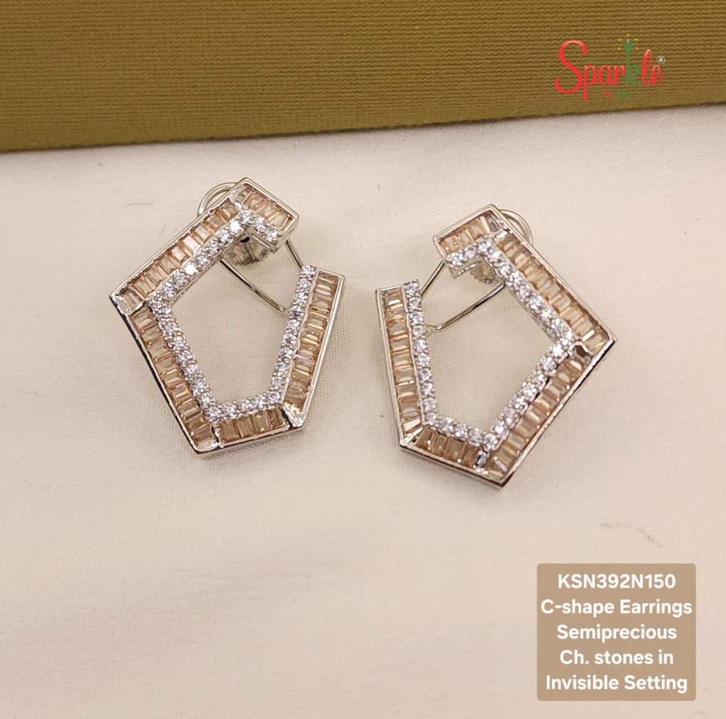 C-shaped earrings with semiprecious stones on a beige background, branded 'SparklebyDJ'.