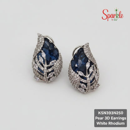 Pear-shaped 3D Blue earrings with white rhodium finish on a beige surface, branded 'SparklebyDJ'.
