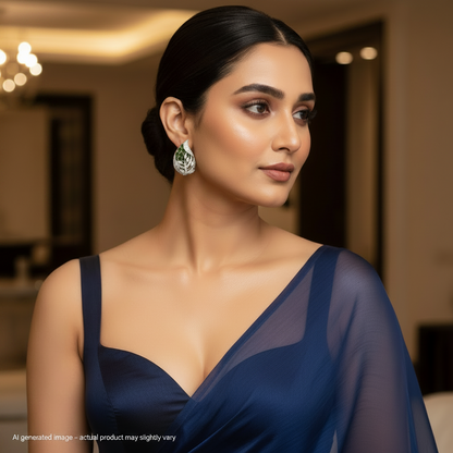 Woman wearing a blue dress with a blurred indoor background with Pear Green earrings