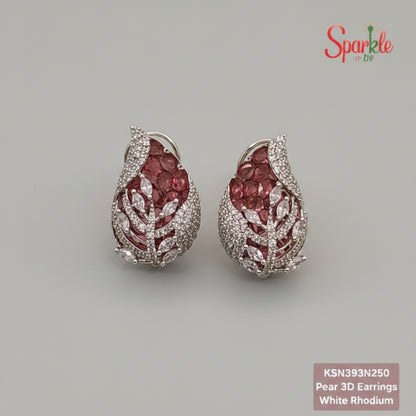 Pair of pear-shaped earrings with pink gemstones and white rhodium plating on a beige surface.
