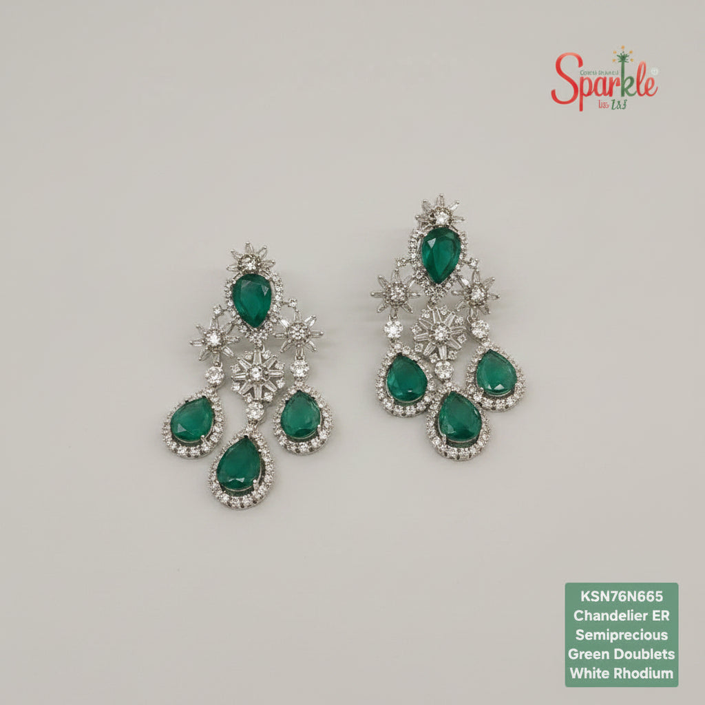 Green gemstone earrings with silver accents on a beige surface, branded 'SparklebyDJ'.