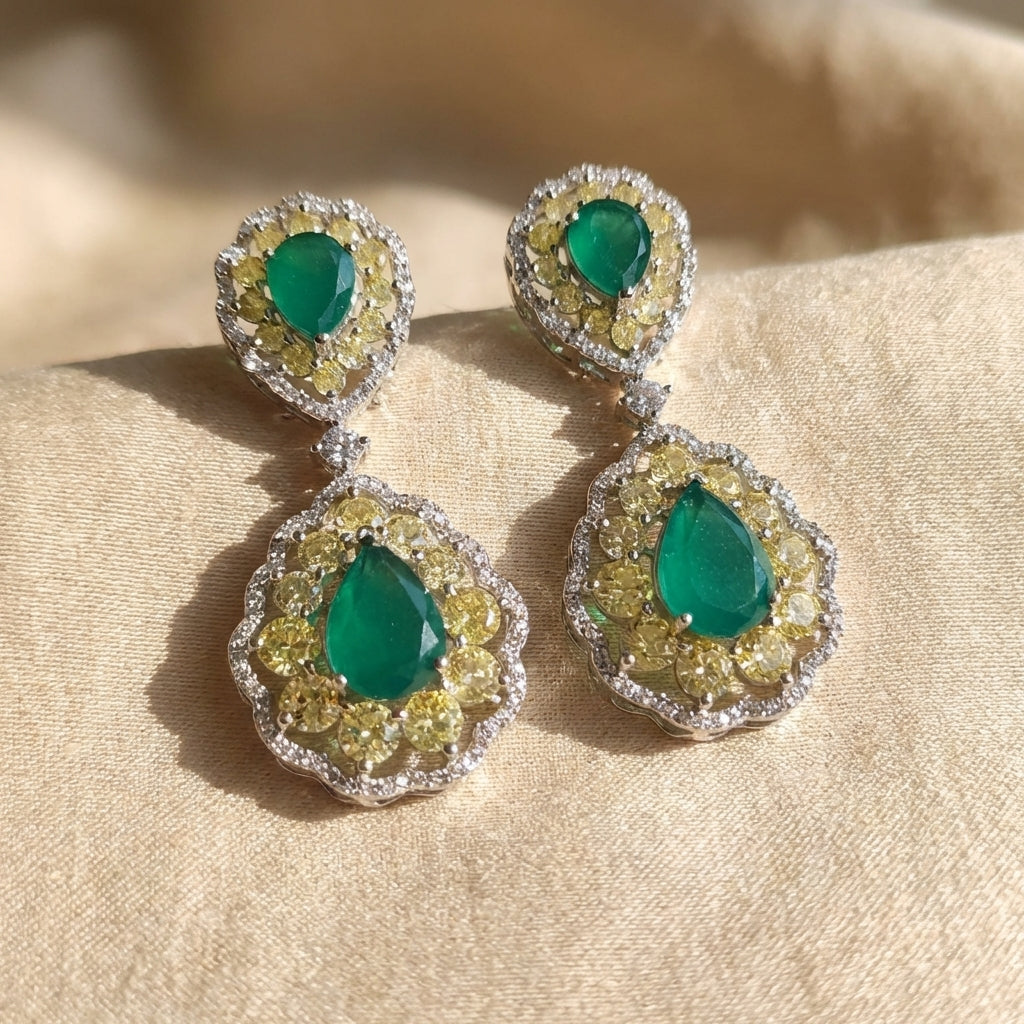 Delicate green doublet earrings shown in macro, highlighting gemstone layers and craftsmanship against a neutral background.