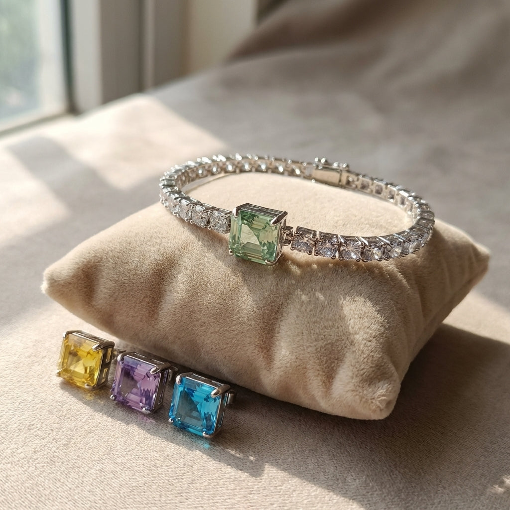 Close-up of a CZ tennis bracelet with four changeable color stones, resting on a velvet cushion, highlighting craftsmanship and micro-textures.
