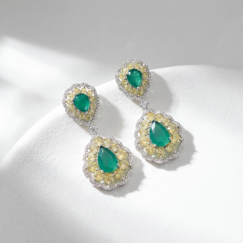 Stylish green doublet earrings on white textured surface, spotlighting micro-details and luxurious design in natural light.